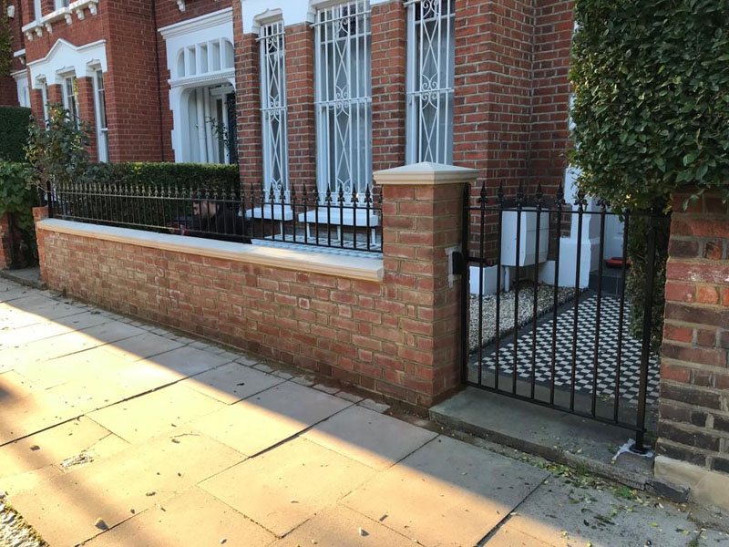 Garden brickwork by Shoots & Leaves, with a neatly pointed brick wall and raised bed